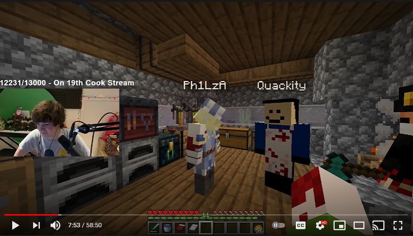 This is a screenshot from Tubbo's stream. He's in Phil's house in L'manberg with Quackity, Fundy, and Ranboo. Phil stands in front of him distraught. Tubbo's facecam shows he's laughing.